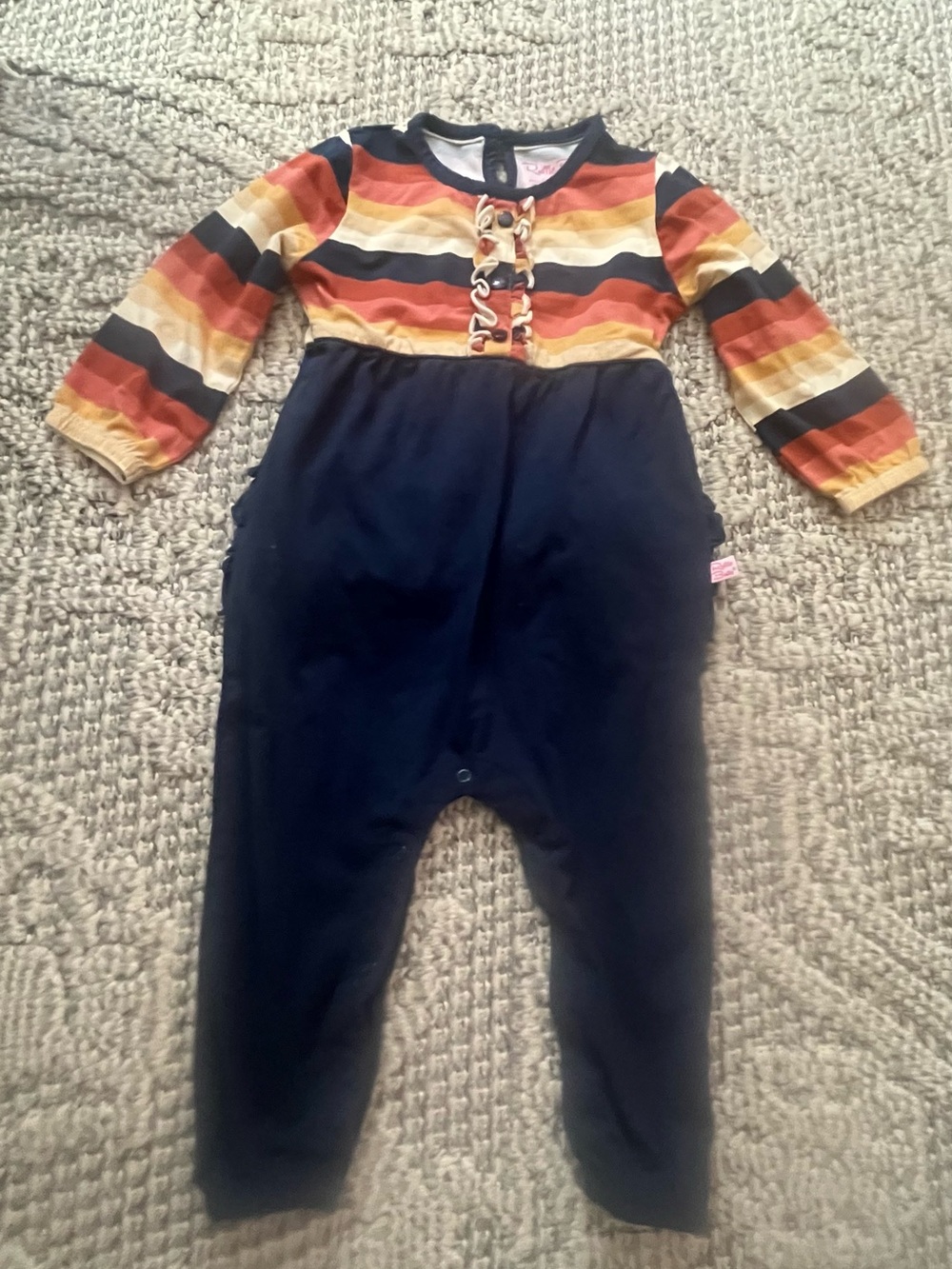 Ruffle Butts Navy Romper with Orange, Yellow & Cream Striped Top